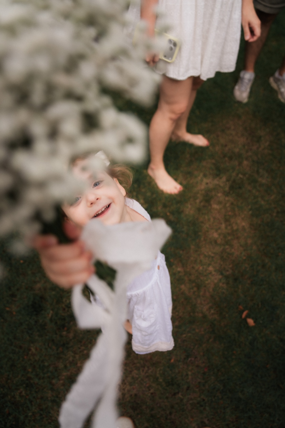Child reaching through a bouquet